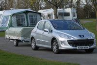 A smaller car with trailer tent