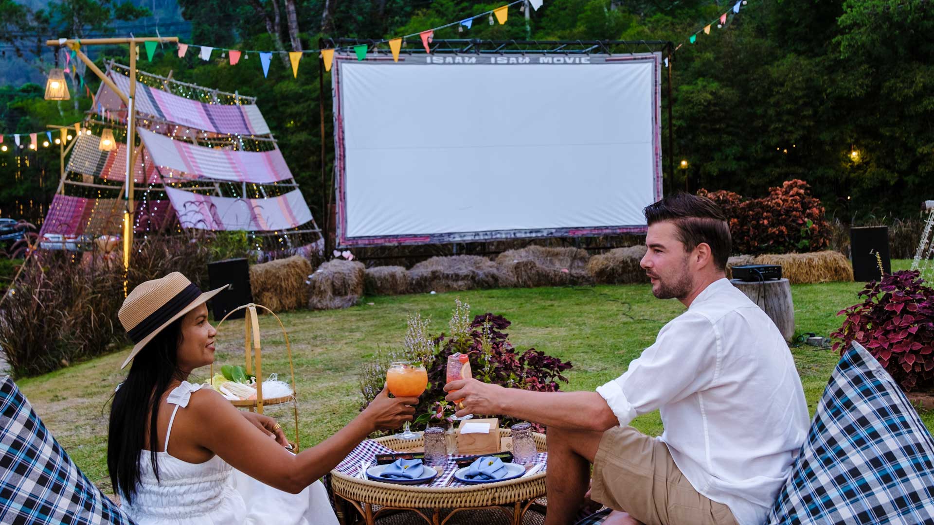 Couple enjoying food and drinks at an outdoor cinema