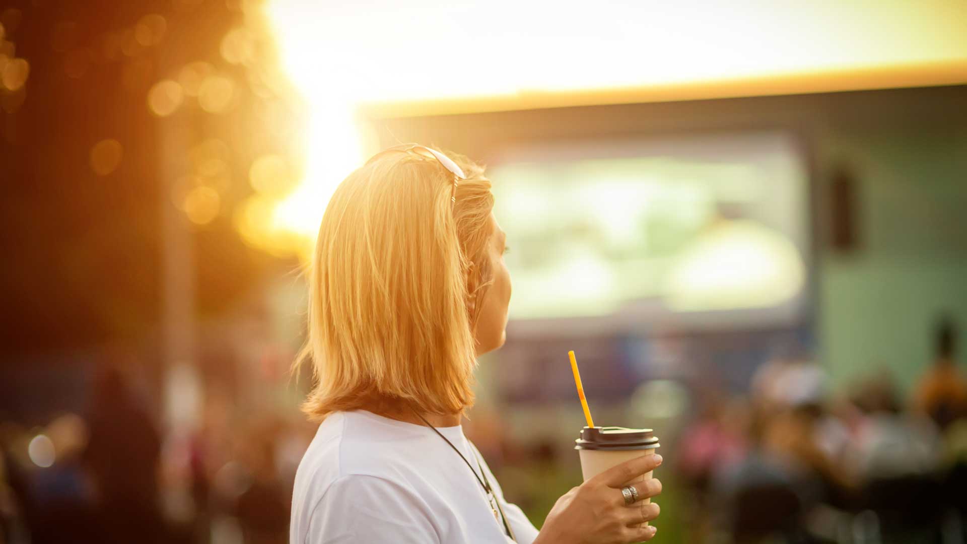 Girl with a drink at an outdoor cinema