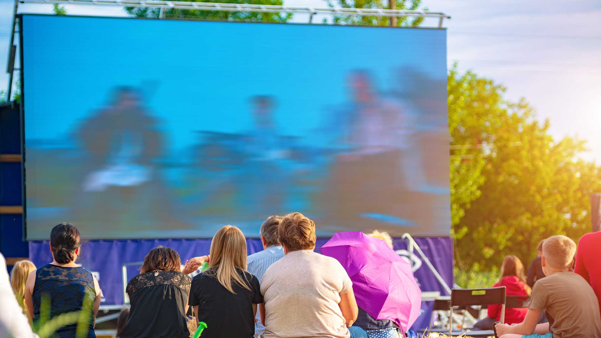 Children and adults at an outdoor cinema