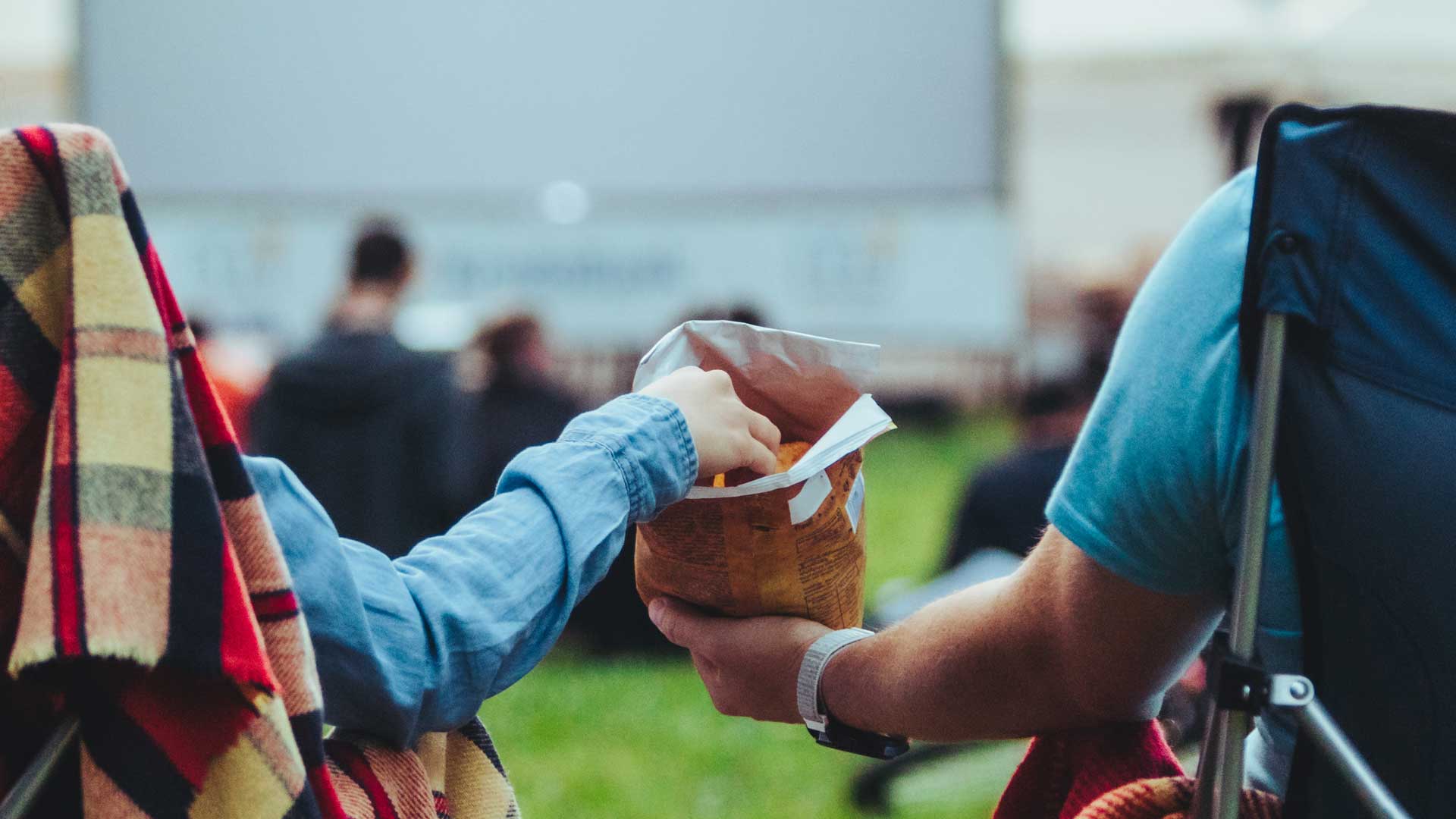 Couple eating at an open-air cinema