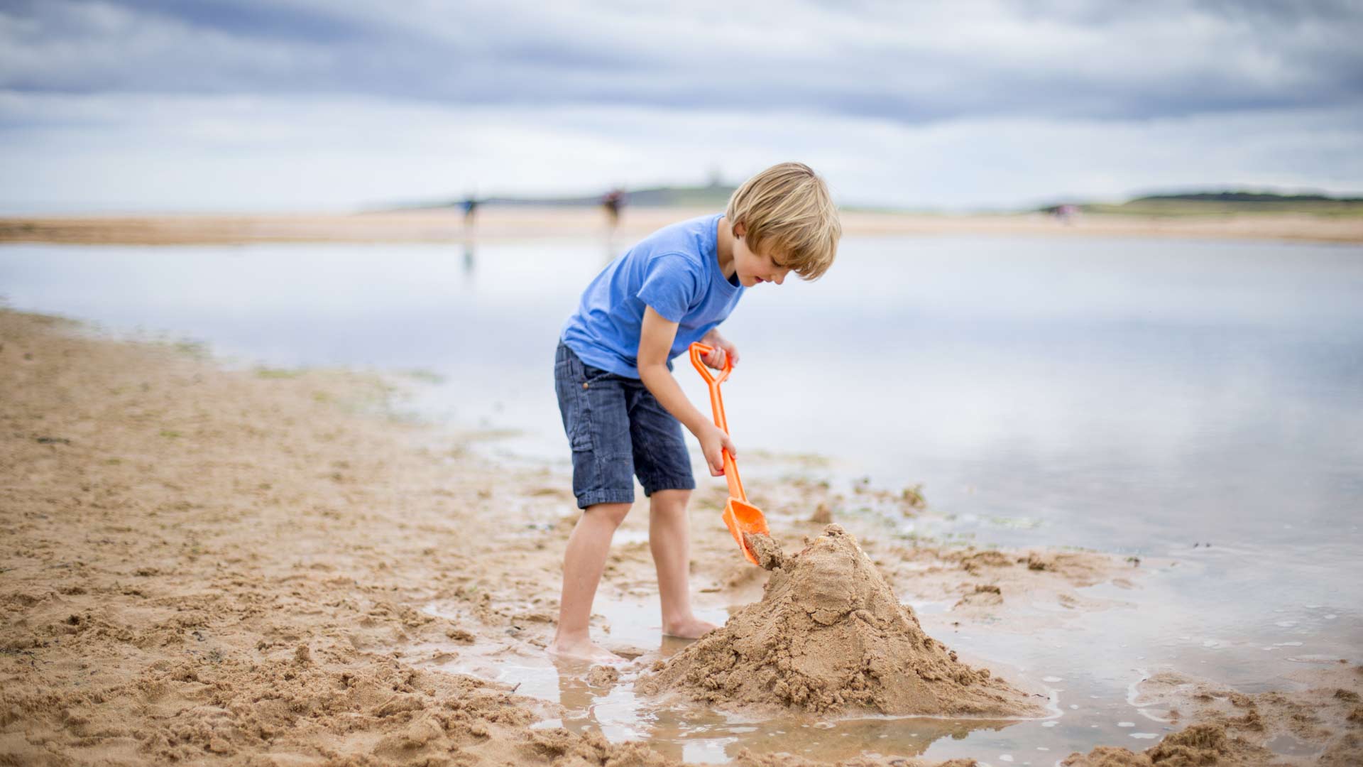 Kid building a sandcastle