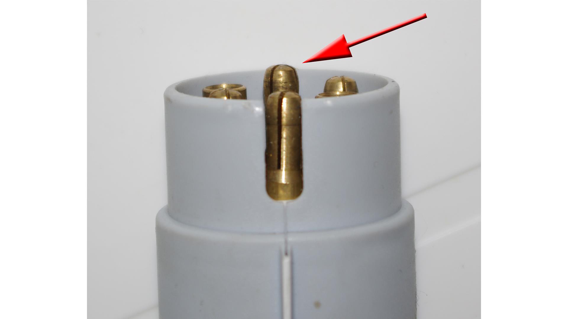 Arrow pointing to the 12S earth pin