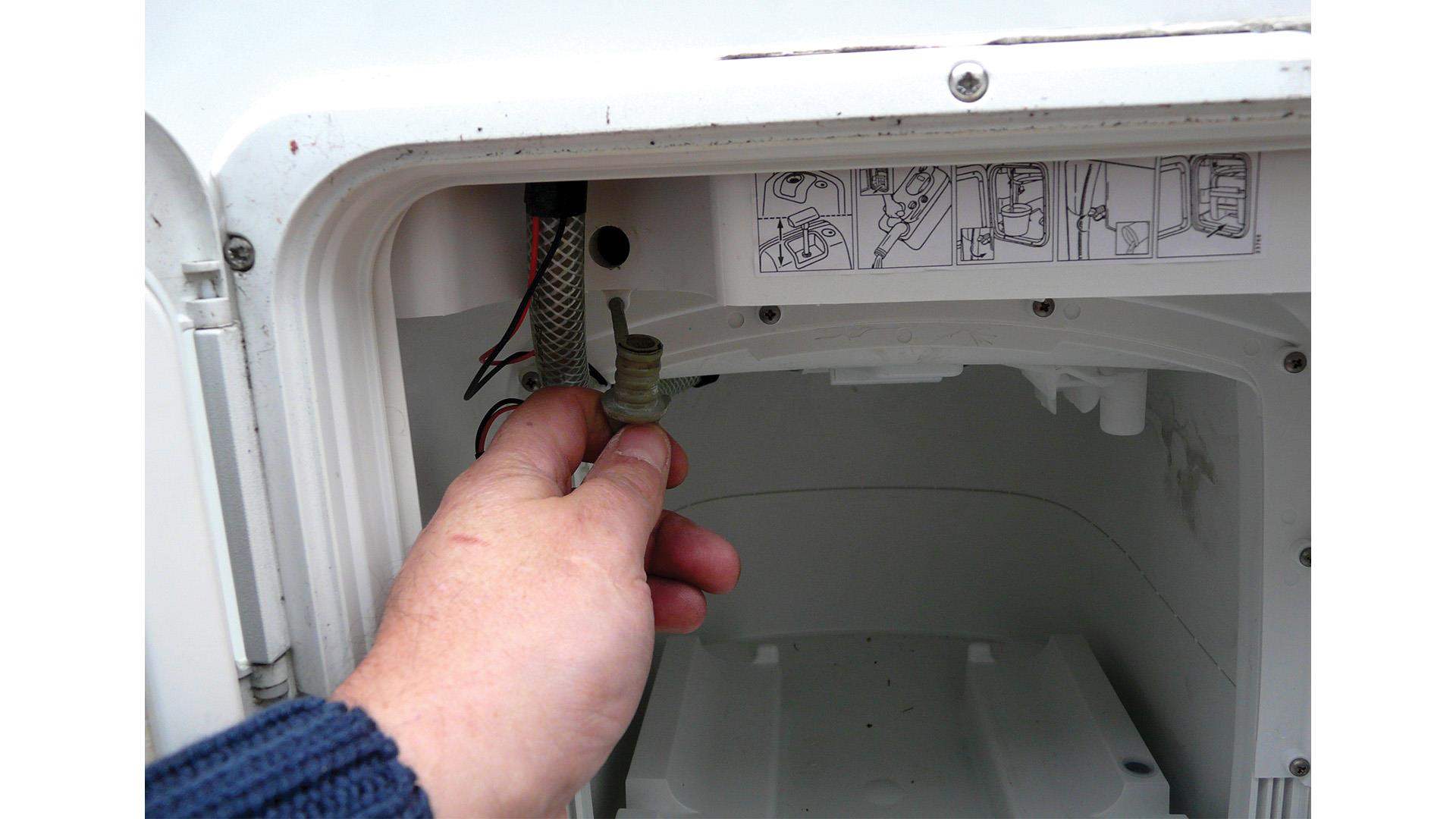 Toilet flush tank drain in a caravan.